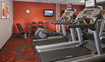 Sonesta ES Suites Birmingham Homewood’s fitness center features treadmills, an elliptical, bench, and rows of free weights, plus a TV.