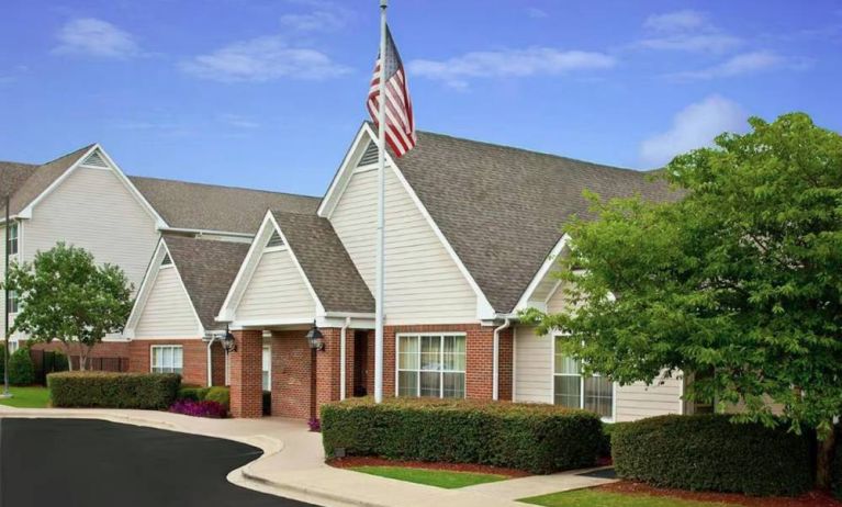 The hotel’s exterior has a fluttering USA flag, and pleasant, well-kept greenery.