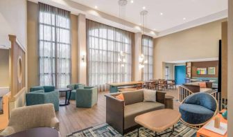 The hotel’s lobby lounge has a high ceiling and full-length windows, comfortable seating including armchairs and sofas, and numerous coffee tables.