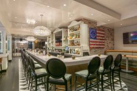 The hotel restaurant has tall stool seating at the bar, an extensive range of beverages, and an artistic 13 star Betsy Ross variant of the Stars and Stripes on the wall.