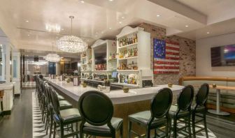 The hotel restaurant has tall stool seating at the bar, an extensive range of beverages, and an artistic 13 star Betsy Ross variant of the Stars and Stripes on the wall.