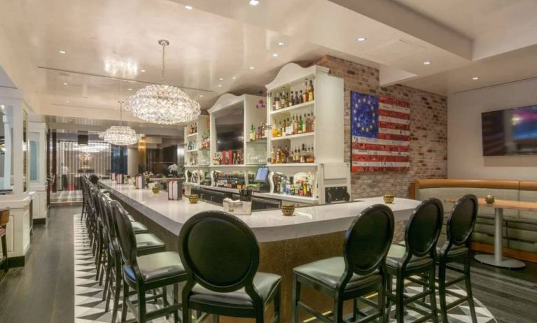 The hotel restaurant has tall stool seating at the bar, an extensive range of beverages, and an artistic 13 star Betsy Ross variant of the Stars and Stripes on the wall.