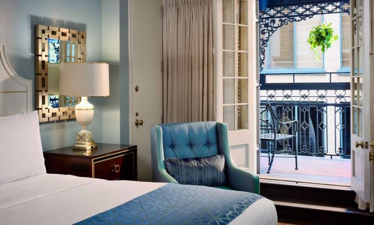 Double bed guest room in Royal Sonesta New Orleans, including armchair and a balcony.