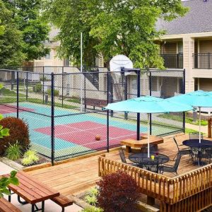 Sonesta ES Suites Atlanta - Perimeter Center North’s terrace is next to the basketball court, and furnished with shaded tables and chairs.