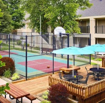 Sonesta ES Suites Atlanta - Perimeter Center North’s terrace is next to the basketball court, and furnished with shaded tables and chairs.