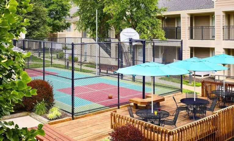 Sonesta ES Suites Atlanta - Perimeter Center North’s terrace is next to the basketball court, and furnished with shaded tables and chairs.