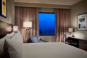 Double bed guest room in Sonesta Bee Cave Austin, with a window and workspace desk, lamp, and chair.