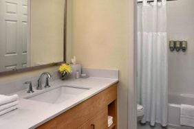 Guest bathroom in Sonesta ES Suites Auburn Hills Detroit, furnished with bath, lavatory, sink, and mirror.