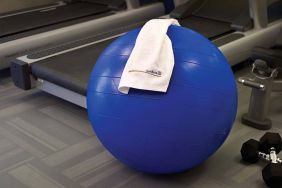 The hotel fitness center has exercise machines including treadmills, alongside equipment such as free weights, gym balls, and benches.