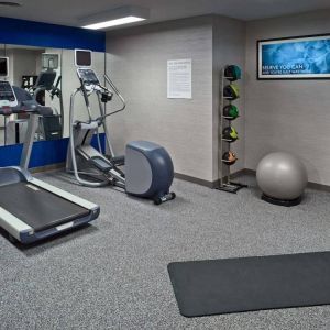 Sonesta ES Suites New Orleans’s fitness center is equipped with gym balls, exercise machines, and plenty of towels.