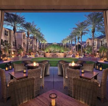 Sonesta Suites Scottsdale Gainey Ranch’s fire pits are surrounded by comfy chairs, with more tables and chairs, and candle-style lights, nearby for outdoor socializing.