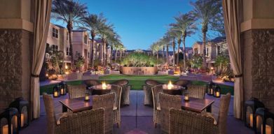 Sonesta Suites Scottsdale Gainey Ranch’s fire pits are surrounded by comfy chairs, with more tables and chairs, and candle-style lights, nearby for outdoor socializing.