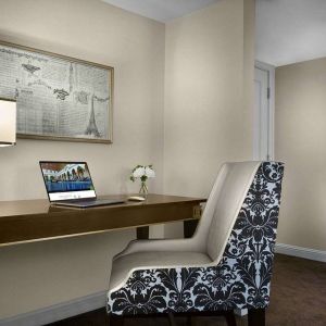 The Chase Park Plaza Royal Sonesta St. Louis guest room workspace, furnished with desk, chair, and lamp.