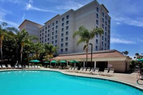 Outdoor pool with pool chairs at Sonesta Anaheim Resort Area.