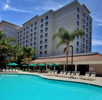 Outdoor pool with pool chairs at Sonesta Anaheim Resort Area.