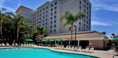 Outdoor pool with pool chairs at Sonesta Anaheim Resort Area.