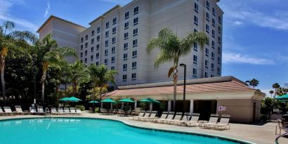 Outdoor pool with pool chairs at Sonesta Anaheim Resort Area.