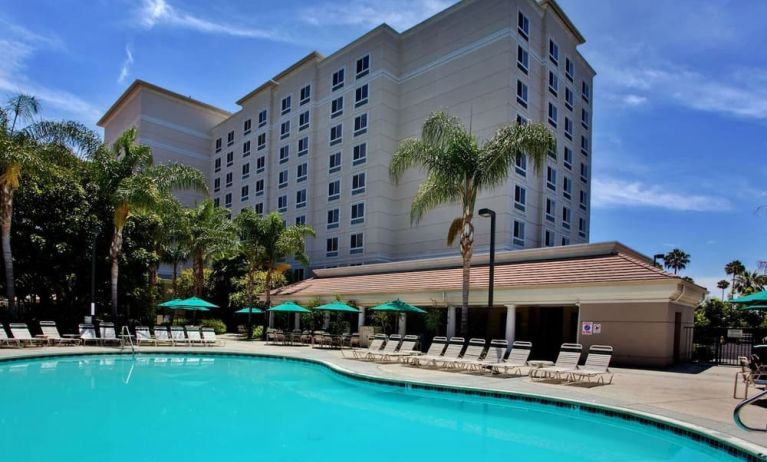 Outdoor pool with pool chairs at Sonesta Anaheim Resort Area.