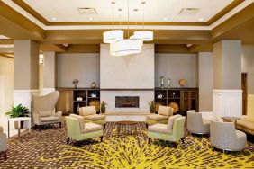 The hotel’s lobby lounge includes a fireplace, armchairs and coffee tables set in a spacious environment.