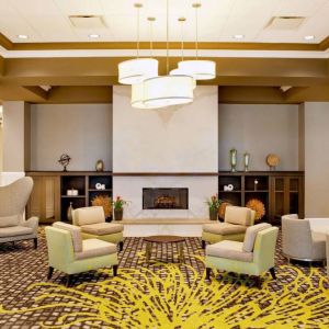 The hotel’s lobby lounge includes a fireplace, armchairs and coffee tables set in a spacious environment.