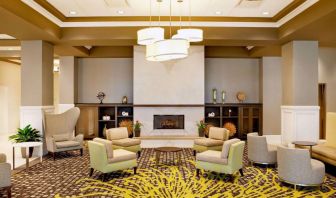 The hotel’s lobby lounge includes a fireplace, armchairs and coffee tables set in a spacious environment.