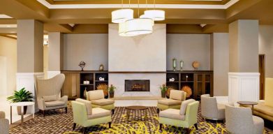 The hotel’s lobby lounge includes a fireplace, armchairs and coffee tables set in a spacious environment.