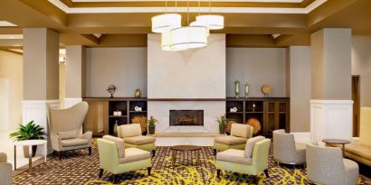 The hotel’s lobby lounge includes a fireplace, armchairs and coffee tables set in a spacious environment.