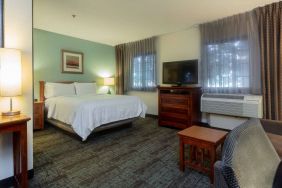 Double bed guest room in Sonesta ES Suites Anaheim Resort Area, including two windows, coffee table, and a television.