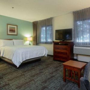 Double bed guest room in Sonesta ES Suites Anaheim Resort Area, including two windows, coffee table, and a television.