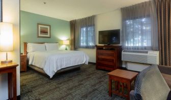 Double bed guest room in Sonesta ES Suites Anaheim Resort Area, including two windows, coffee table, and a television.