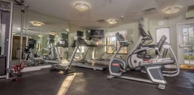 Sonesta ES Suites Anaheim Resort Area’s fitness center is equipped with a wide range of different exercise machines, and has a wall-mounted television.