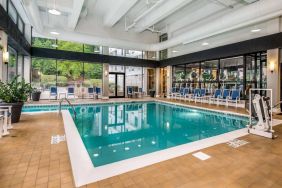 The hotel’s indoor pool includes a lift, has chairs by the side, and large windows to let in plenty of natural light.