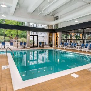 The hotel’s indoor pool includes a lift, has chairs by the side, and large windows to let in plenty of natural light.