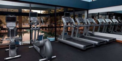 The fitness center at Sonesta Charlotte Executive Park has assorted exercise machines, and large windows that overlook the pool.