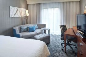 Delux king room with couch and workspace at Sonesta Select Milwaukee Brookfield.