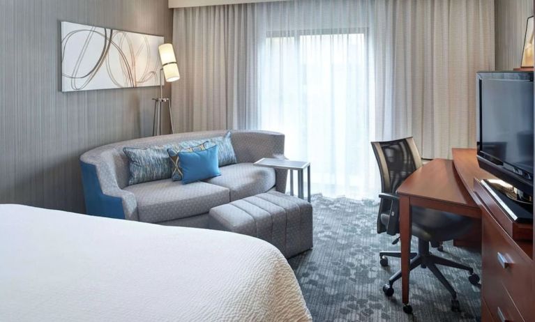 Delux king room with couch and workspace at Sonesta Select Milwaukee Brookfield.