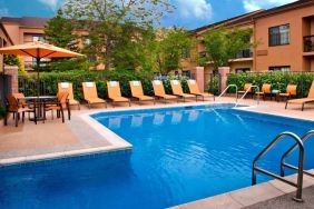 The hotel’s outdoor pool has a direct water link to the indoor pool, and has a shaded table and chairs as well as sun loungers by the side.