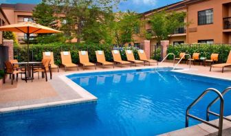 The hotel’s outdoor pool has a direct water link to the indoor pool, and has a shaded table and chairs as well as sun loungers by the side.