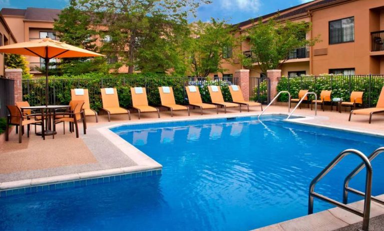 The hotel’s outdoor pool has a direct water link to the indoor pool, and has a shaded table and chairs as well as sun loungers by the side.