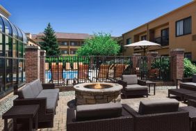 Sonesta Select Newport Middletown’s fire pit has comfortable armchair and sofa seating nearby, and is close to the pool.