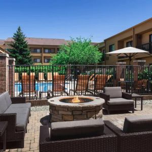 Sonesta Select Newport Middletown’s fire pit has comfortable armchair and sofa seating nearby, and is close to the pool.