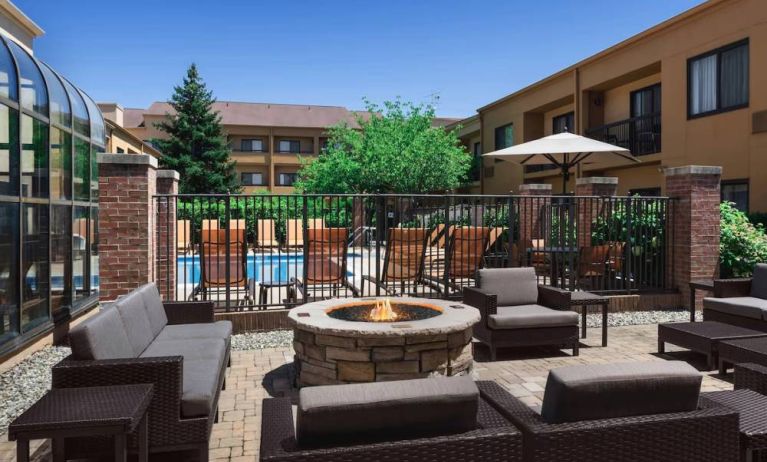 Sonesta Select Newport Middletown’s fire pit has comfortable armchair and sofa seating nearby, and is close to the pool.