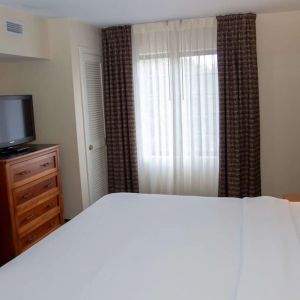 Sonesta ES Suites San Antonio Northwest - Medical Center guest room, furnished with double bed and widescreen television.