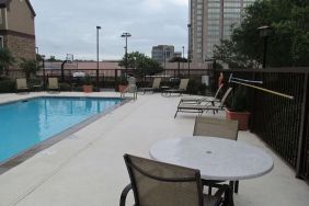 Sonesta ES Suites San Antonio Northwest - Medical Center’s outdoor pool is ringed by a fence, and has nearby tables and chairs, as well as sun loungers.