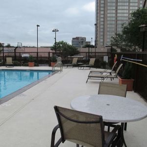 Sonesta ES Suites San Antonio Northwest - Medical Center’s outdoor pool is ringed by a fence, and has nearby tables and chairs, as well as sun loungers.