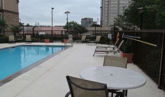 Sonesta ES Suites San Antonio Northwest - Medical Center’s outdoor pool is ringed by a fence, and has nearby tables and chairs, as well as sun loungers.