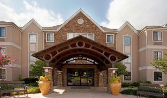 Sonesta ES Suites San Antonio Northwest - Medical Center’s exterior has pleasant greenery and benches, and a covered entranceway.