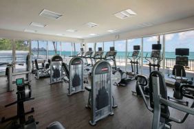 The fitness center in Royal Sonesta San Juan is equipped with a large array of exercise machines, and large windows overlooking the beach.