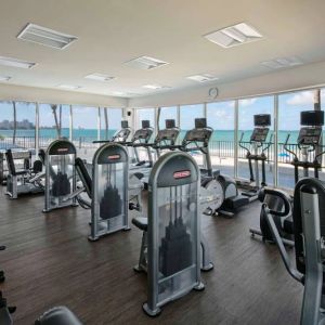 The fitness center in Royal Sonesta San Juan is equipped with a large array of exercise machines, and large windows overlooking the beach.