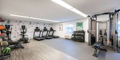 Sonesta Simply Suites Jersey City’s fitness center is equipped with free weights, a variety of exercise machines, gym balls, and art on the walls.